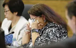  ?? RICH PEDRONCELL­I / ASSOCIATED PRESS ?? Dana Dillion, a member of the California State Teacher’s Retirement System Investment Committee, wipes her eyes during a discussion about school shootings Wednesday in West Sacramento, Calif.