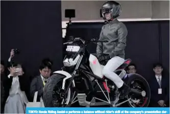  ?? —AFP ?? TOKYO: Honda Riding Assist-e performs a balance without rider’s skill at the company’s presentati­on during the Tokyo Motor Show in Tokyo yesterday.