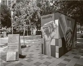  ?? Hadley Chittum / Staff photograph­er ?? The words “equality,” “kindness” and “love” are featured on three sides of the four-sided “Hands of Heroes” installati­on at Discovery Green.