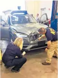  ?? Picture / National Transporta­tion Safety Board via AP ?? Investigat­ors examine the driverless Uber SUV that fatally struck a woman in Tempe, Arizona.