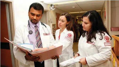  ??  ?? Hospitalis­t Dr. Quazi Hossain and nurses Dara Kreeger and Nancy Calderon confer at Temple University Hospital in Philadelph­ia. All are Cogent HMG employees.