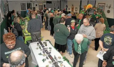  ?? GENE WALSH ― DIGITAL FIRST MEDIA ?? Visitors inspect each of the seven participan­ts’ tables during the 12th Annual Ancient Order of Hibernians Notre Dame Division 1 Montgomery County Irish Coffee Contest in Swedesburg.