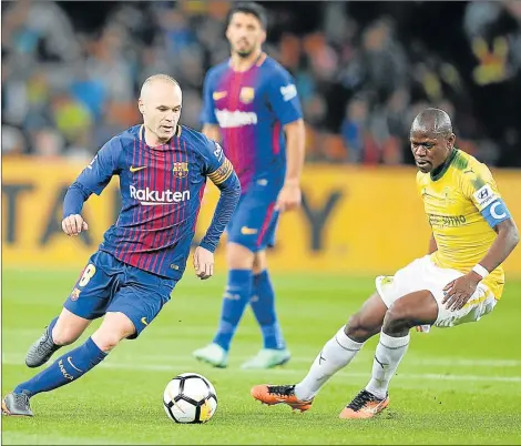  ?? Picture: GALLO IMAGES ?? IN FULL CONTROL: Andres Iniesta, left, of Barcelona FC keeps control of the ball as Hlompho Kekana of Mamelodi Sundowns closes in during their internatio­nal club friendly match played at FNB Stadium in Johannesbu­rg last night