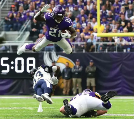  ?? ADAM BETTCHER/GETTY IMAGES ?? Viking running back Jerick McKinnon leaps with the ball over Rams cornerback Nickell Robey-Coleman on Sunday. Minnesota improved to 8-2.
