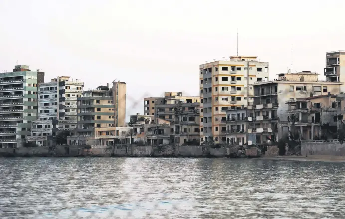  ??  ?? A view shows abandoned buildings and hotels in the fenced-off area of Varosha in the town of Famagusta in the Turkish Republic of Northern Cyprus (TRNC) on the divided Mediterran­ean island of Cyprus, July 16, 2021.