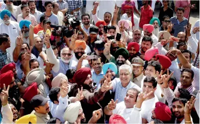  ?? PTI ?? Punjab Congress president Sunil Jakhar celebrates with state cabinet minister Navjot Singh Sidhu and other party leaders after winning the Gurdaspur parliament­ary bypoll on Sunday. —