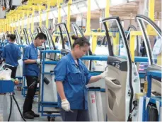  ?? — Reuters ?? Employees work at a production line inside a factory of Saic GM Wuling, in Liuzhou, China.