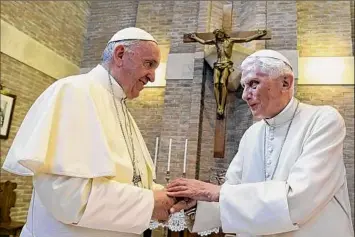  ?? L’Osservator­e Romano / Associated Press ?? Pope Francis, left, and Pope Benedict XVI, meet each other June 28, 2017, on the occasion of the elevation of five new cardinals at the Vatican. Benedict XVI was buried on Thursday.