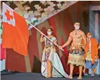  ?? — AP, AFP ?? Right: Pita Taufatofua (right) leads Tonga at the opening ceremony, carrying his country’s flag a third time, continuing his streak from Rio 2016 and PyeongChan­g 2018. He also went shirtless in 2016. The 37-year-old has represente­d Tonga at both the Summer (taekwondo) as well as Winter Games (cross-country skiing).