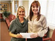  ??  ?? Cindy Hinson, left, president of HomeAid Houston receives a check from GHBA CEO, Casey Morgan from proceeds raised through the GHBA’s fundraiser, the Benefit Homes Project.