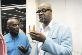  ?? ?? Mount Pleasant Farm Chocolatie­rs founder Averell French (left) introduced Jamaica Observer Table Talk Food Awards judge Professor Lloyd Waller to his chocolate wine.