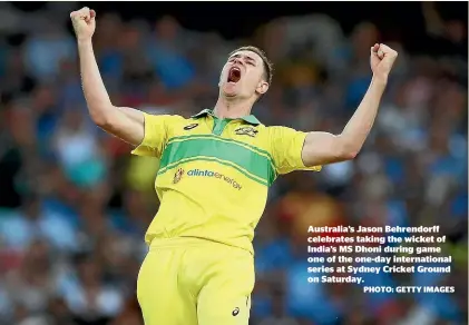  ??  ?? Australia’s Jason Behrendorf­f celebrates taking the wicket of India’s MS Dhoni during game one of the one-day internatio­nal series at Sydney Cricket Ground on Saturday.