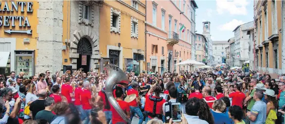  ??  ?? A roving big brass band delights the crowd at the Umbria Jazz Festival in Perugia, Italy. The Umbria region is sometimes compared to Tuscany with its abundant food, wine and vistas.