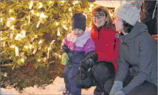  ?? ERIC MCCARTHY/ JOURNAL PIONEER FILE PHOTO ?? Indiana Hogan with her mom, Stephanie Hogan, right and grandmothe­r Barbara McInnis check the bulbs on last year’s Tignish Health Co-op Centre’s Memorial Christmas Tree. This year’s tree-lighting is set for Dec. 11 at 6 p.m. Memorial tags for the bulbs can be purchased at the Heath Centre’s front counter and from community volunteers.