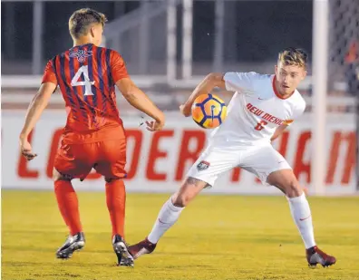  ?? JIM THOMPSON/JOURNAL ?? New Mexico’s Aaron Scott and St. Mary’s Valentin Spooner vie for control of the ball during Wednesday’s game at the UNM Soccer Complex. St. Mary’s scored with just 20 seconds left in the match to take a 1-0 victory.