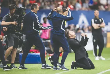  ?? DARRYL DYCK/THE CANADIAN PRESS ?? Vancouver Whitecaps head coach Marc Dos Santos, bottom right, hasn’t had many moments this season to celebrate as he did on May 10, when Vancouver defeated the Portland Timbers 1-0 at home.