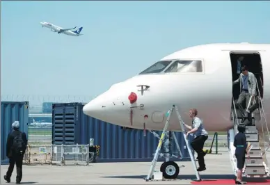  ?? GAO ERQIANG / CHINA DAILY ?? A business jet on display attracts visitors at the 2018 ABACE air fair in Shanghai.