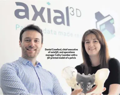  ??  ?? Daniel Crawford, chief executive
of axial3D, and operations manager Cathy Coomber with a
3D-printed model of a pelvis