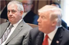  ?? AP ?? Secretary of State Rex Tillerson (left), listens to President Donald Trump speak during a cabinet meeting at the White House yesterday.