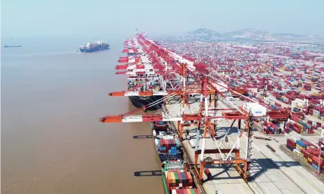  ??  ?? Economic globalizat­ion has forcefully boosted the rapid developmen­t of China’s industrial­ization, making China an economy with the most complete distributi­on of industrial sectors across the globe. Drone photo taken on March 18, 2020 shows the Container Terminal of the Yangshan Port, Shanghai.