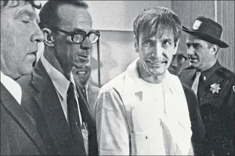  ??  ?? Gary Gilmore in maximum security prison uniform, going to receive his execution date