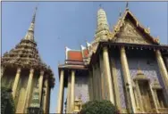  ?? COURTNEY BONNELL — THE ASSOCIATED PRESS ?? This photo shows two ornate buildings at Wat Phra Kaew, or the Temple of the Emerald Buddha, in Bangkok. They are just across from the main structure housing the most sacred statue in Thailand, the Emerald Buddha, which is actually carved of jade and...