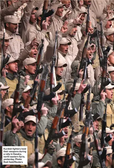  ??  ?? Kurdish fighters hold their weapons during a rally in Hasaka, north-eastern Syria, yesterday. Photo: Rodi Said/Reuters