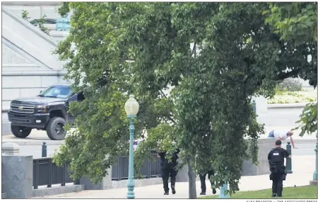  ?? ALEX BRANDON — THE ASSOCIATED PRESS ?? A person is apprehende­d after being in a pickup truck parked on the sidewalk in front of the Library of Congress’ Thomas Jefferson Building, as seen from a window of the U.S. Capitol Aug. 19, in Washington. Officials evacuated a number of buildings around the Capitol and sent snipers to the area after officers saw a man holding what looked like a detonator inside the pickup, which had no license plates. The man was identified as Floyd Ray Roseberry, 49, of Grover, North Carolina, according to two people briefed on the matter.