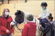  ?? Anne Hermes / Contribute­d photo ?? Alice Daly, left, volunteer with Little Britches, with program participan­ts.