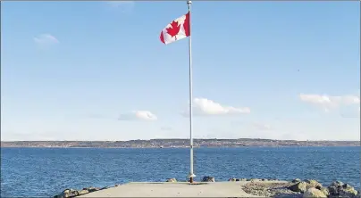  ?? SUBMITTED PHOTOS ?? This photo taken from the end of the breakwater at the Indian Beach shows the wharf (just to the left of the flag pole), which was the foundation of the South Bar Lighthouse.