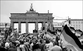  ??  ?? People wave German flags during an AfD rally at the Brandenbur­g Gate in Berlin. (Photo: EPA)