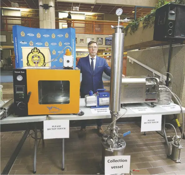  ?? Greg Southam ?? Sgt. Guy Pilon shows off equipment seized recently by police from a cannabis extraction lab. Pilon is encouragin­g citizens to contact police regarding suspicious behaviour following the recent discovery of three residentia­l labs, two of which resulted in significan­t explosions and fires.