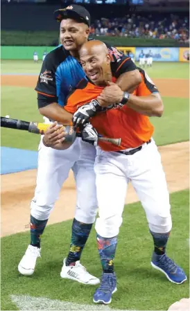  ?? | WILFREDO LEE/ AP ?? Starlin Castro shares a light moment with Cubs coach Franklin Font ( right) before the Home Run Derby. “I’mhappy to be an All- Star again,” Castro said.