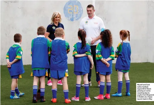  ??  ?? Myself and Cork ladies football legend Brid Stack passing on some coaching tips to pupils from Ringsend in Dublin at a Topaz launch back in May