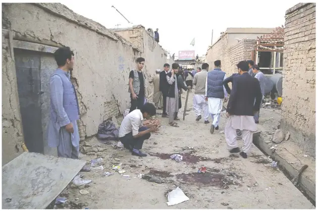  ?? AGENCE FRANCE-PRESSE ?? RESIDENTS gather at a site following a suicide bomber blew himself up in an education centre, in Kabul. The suicide attack killed at least 18 people.