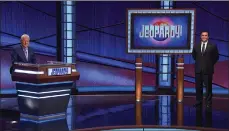  ?? Photo courtesy of Jeopardy Production­s Inc. ?? Santa Clarita Navy officer Phillip Howard, right, competes on “Jeopardy,” appears socially distanced from the game show’s host Alex Trebek. Trebek died Nov. 8 after a battle with pancreatic cancer. He was 80. The final episode of “Jeopardy” with Trebek as host airs today.