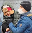  ??  ?? TURNED BACK: A father and son on the Turkish border with Greece