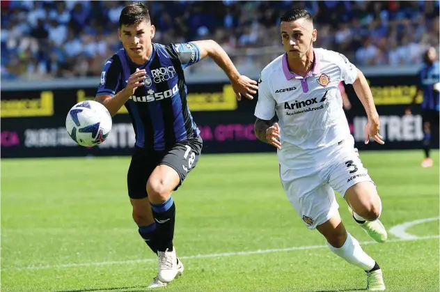  ?? Agencefran­ce-presse ?? Atalanta’s Ruslan Malinovsky­i (left) fights for the ball with Cremonese’s Emanuele Valeri during their Italian League match on Sunday.