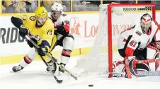  ??  ?? Senators defenceman Mark Borowiecki pushes Predators defenceman Nick Bonino off the puck on goaltender Craig Anderson’s doorstep in the second period Monday.