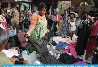  ?? ?? ACCRA, Ghana: People go through secondhand clothes at the Kantamanto market in Accra, Ghana. – AFP
