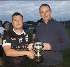  ??  ?? Newtown captain Dean Odlum collects the Division 2 cup from Wicklow County Chairman Martin Fitzgerald.