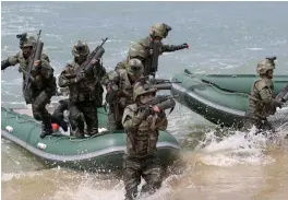  ?? — AP ?? A special operation forces training of North Korean army that simulated attacks on S. Korean islands at an undisclose­d location in North Korea on Saturday.