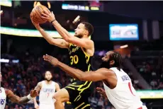  ?? — AFP photo ?? Curry (top) is guarded by James Harden of the LA Clippers at Chase Centre in San Francisco, California.