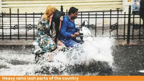  ?? PTI ?? Commuters ride through a waterlogge­d street during heavy pre-monsoon rainfall, in Lucknow yesterday. The India Meteorolog­ical Department (IMD) forecast “very heavy” rainfall in parts of the country, including Maharashtr­a and Goa, over the weekend and...