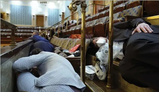  ?? ASSOCIATED PRESS ?? People shelter in the House gallery as protesters try to break into the House Chamber at the U.S. Capitol on Wednesday.