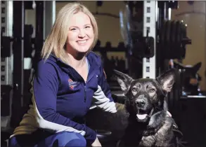  ?? Bob Luckey Jr. / Hearst Connecticu­t Media ?? Greenwich resident Amy Dixon, a triathlete who is blind, with her German Shepherd service dog Woodstock at Combine Training in Greenwich.