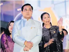 ??  ?? Prime Minister Prayut Chan-o-cha is briefed by Tourism and Sports Minister Kobkarn Wattanavra­ngkul at the Thailand Tourism Festival.