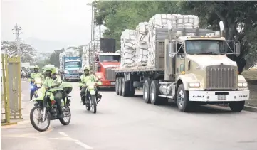  ??  ?? File photo shows police escorting trucks arriving at a warehouse, where internatio­nal humanitari­an aid forVenezue­la will be stored according to authoritie­s, near the Tienditas cross-border bridge between Colombia and Venezuela, in Cucuta, Colombia. — Reuters photo