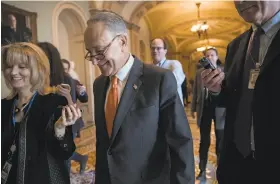  ?? J. Scott Applewhite / Associated Press ?? Senate Minority Leader Chuck Schumer, D-N.Y., leaves a meeting with Senate Majority Leader Mitch McConnell, R-Ky., on keeping the government open.