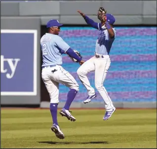  ?? Associated Press ?? FINALE — Kansas City Royals center fielder Michael A. Taylor (2) and right fielder Jarrod Dyson (1) celebrate following a baseball game against the Los Angeles Angels at Kauffman Stadium in Kansas City, Mo. on Wednesday. The Royals defeated the Angels 6-1.